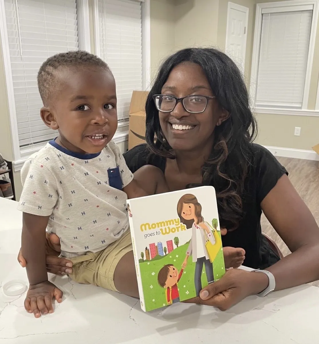 A mother and her son holding the book