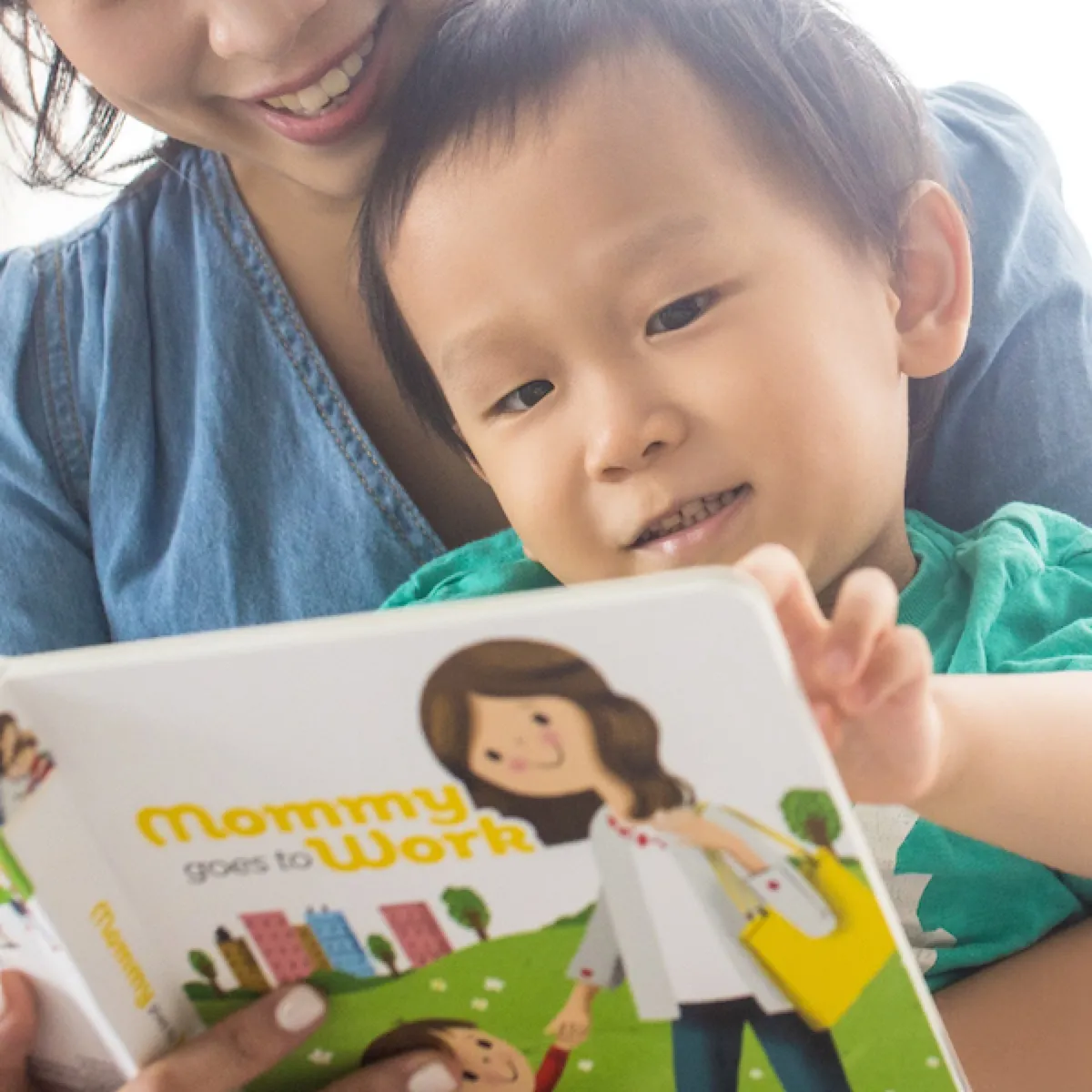 A mother and her son turning a page together