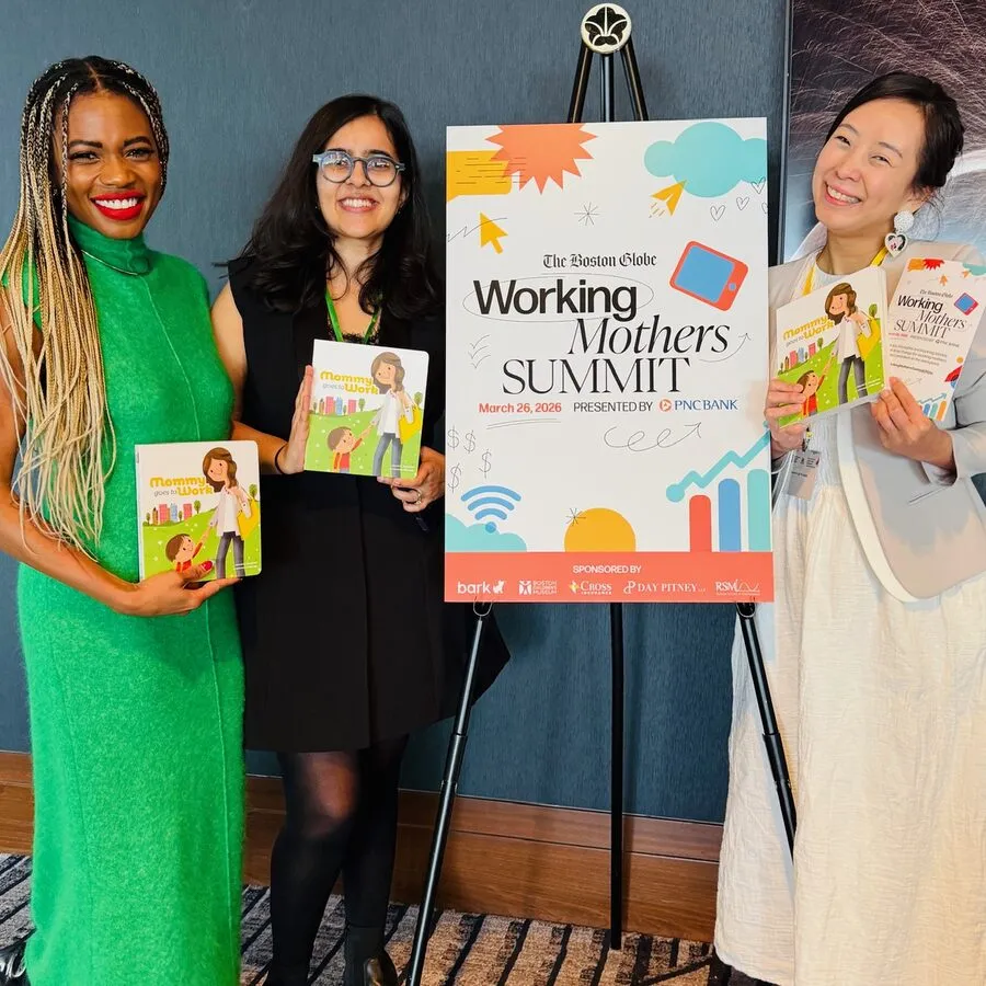 Three women holding the book at the Boston Globe Working Mothers Summit